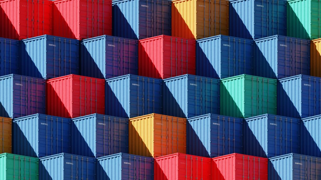 Colourful containers stacked with diagonal shadow.