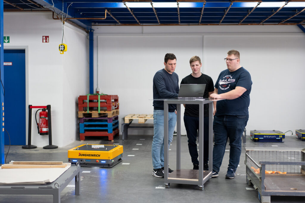 Jungheinrich employees assisting customers with the use of Autonomous Mobile Robots (AMRs)  