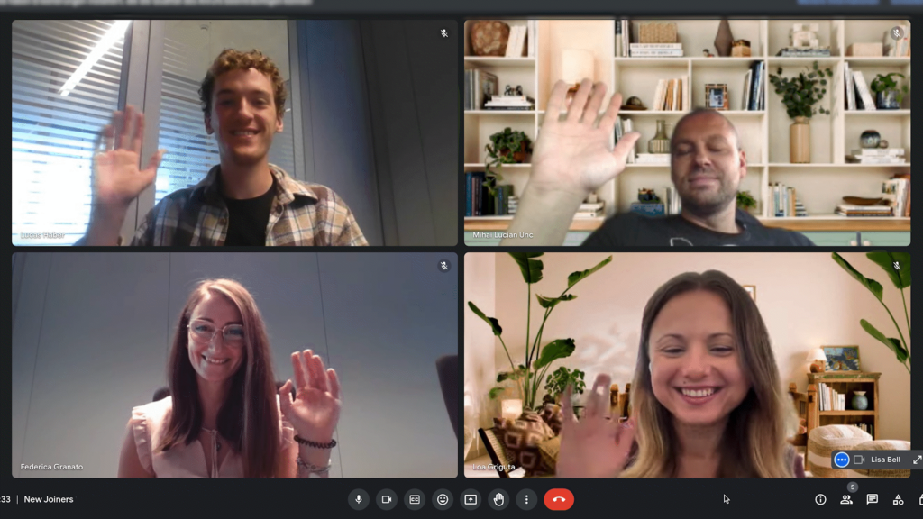 Screenshot of a videocall showing four people waving to the camera