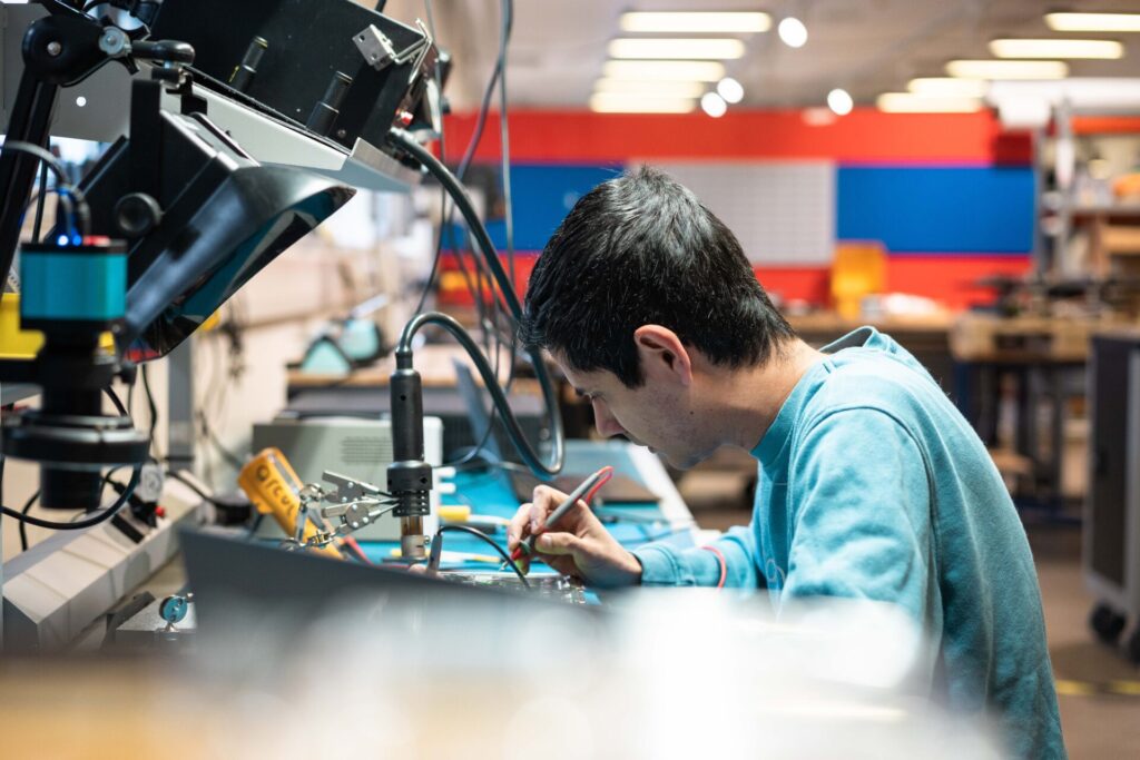Shows one of the developers from the Electronics department busy soldering in the arculus electronics lab